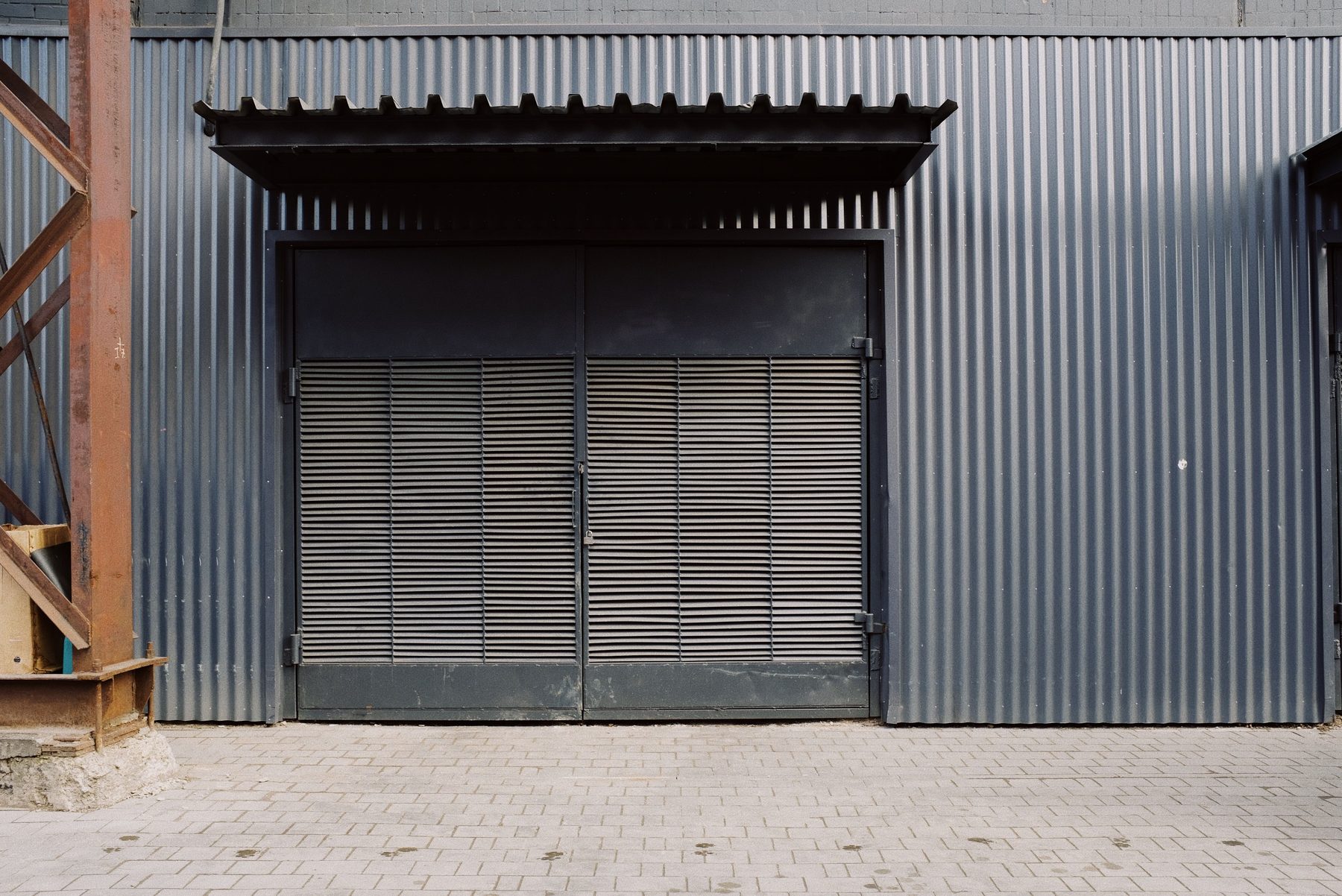 A steel-clad single-tenant industrial unit with a loading bay